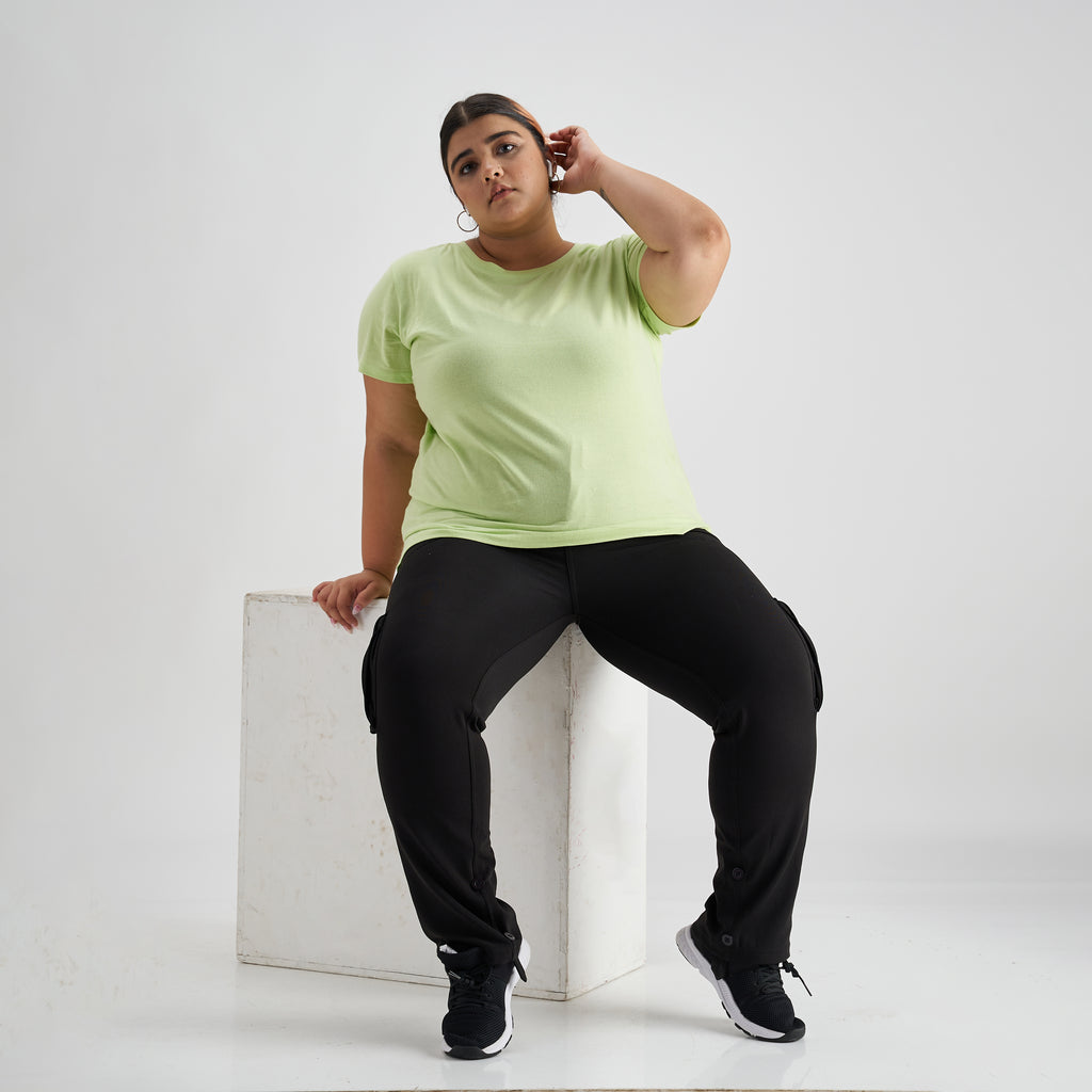 A fat woman is engaged in fitness in the gym. A girl with a lot of  overweight trying to lose weight with the help of sports, does stretching  exercises Stock Photo -
